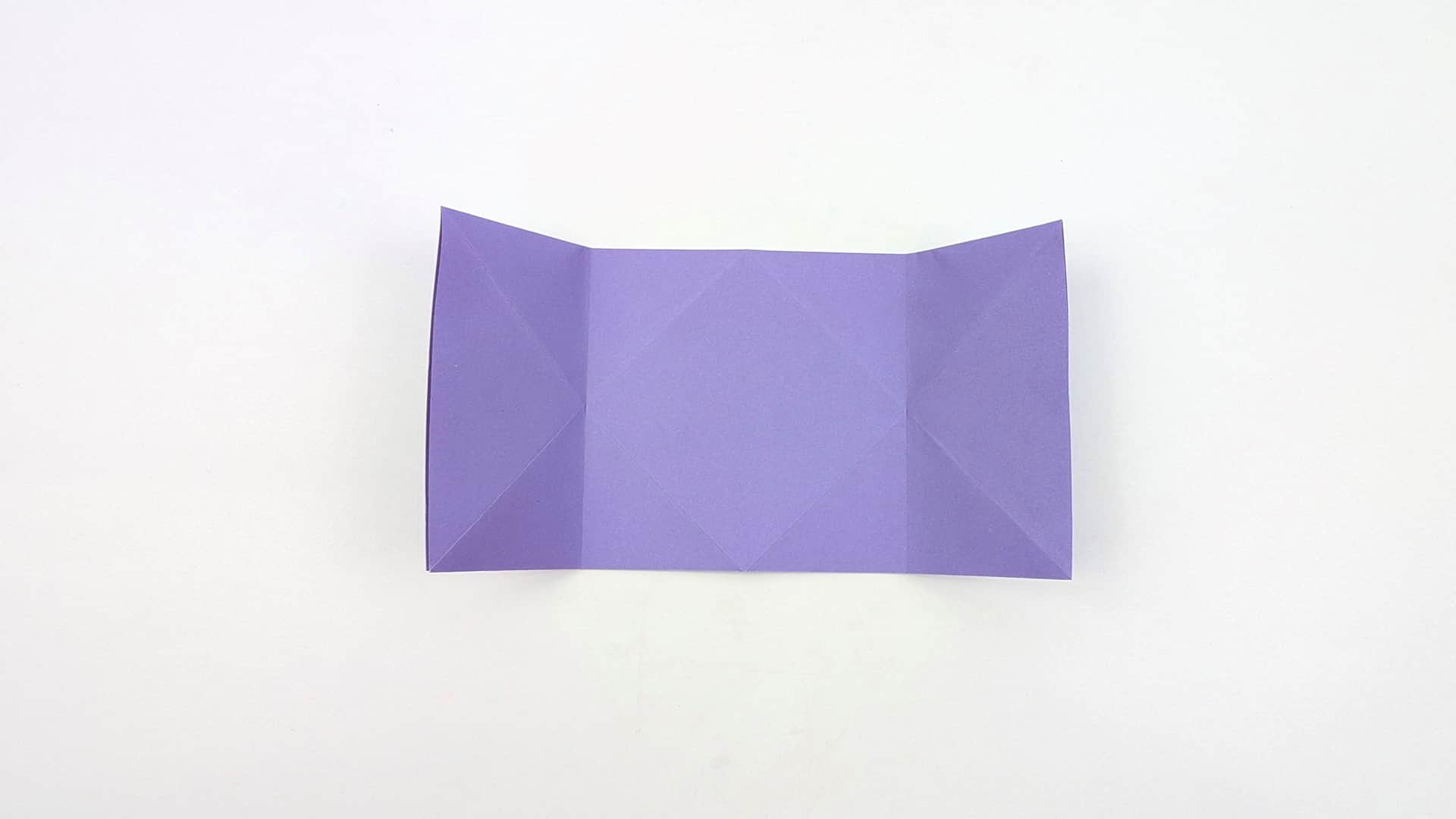 Open everything out flat. You now see the full crease map — a wide landscape rectangle with three-panel divisions and all diagonal lines.