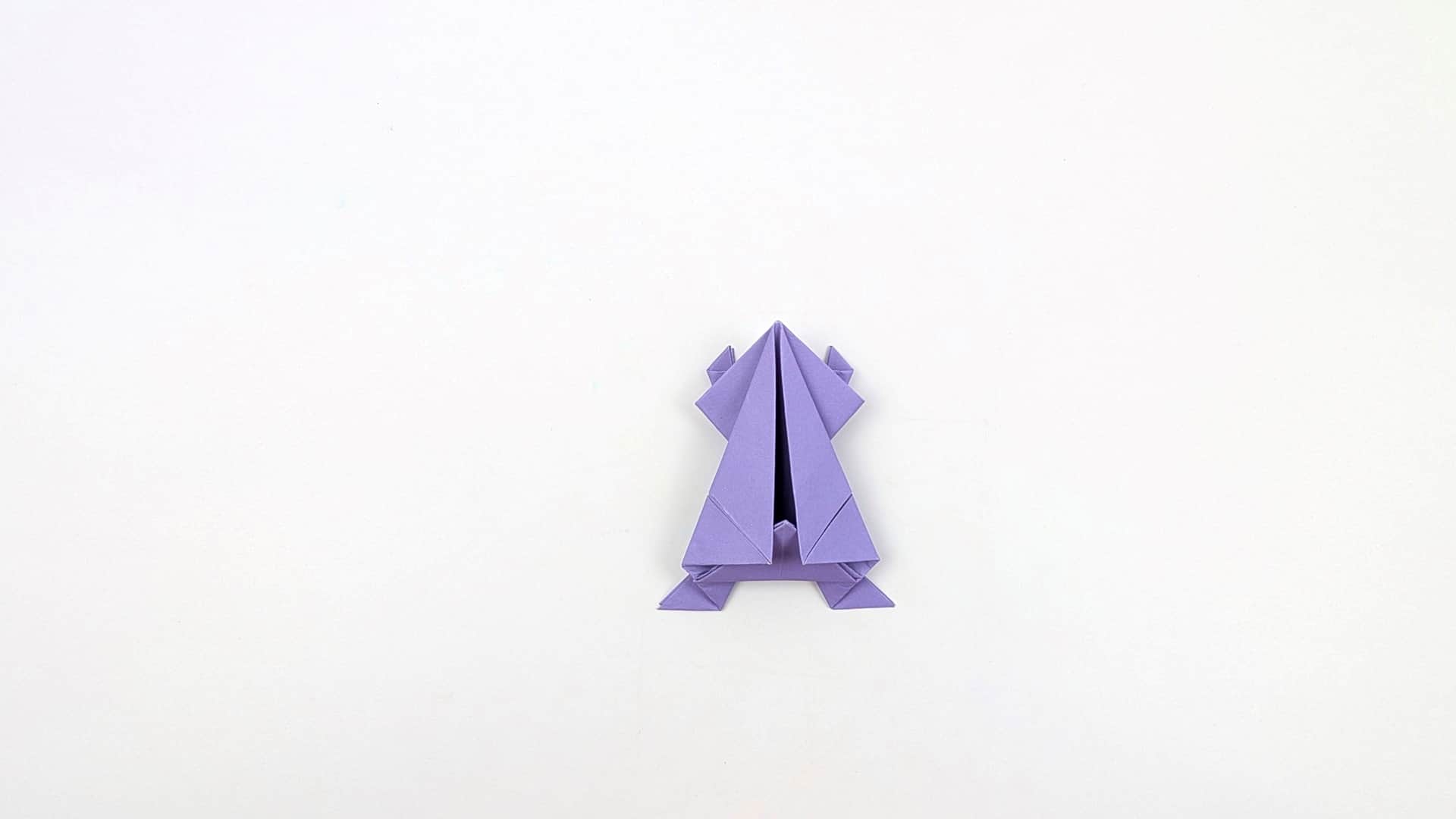 Fold the internal center layers back to create the jump spring. A deep inverted-V crease forms inside the body.