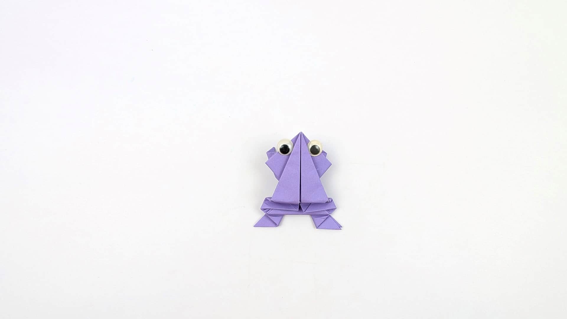 Glue two googly eyes to the front of the head. Press down on the back and release — the frog leaps forward!