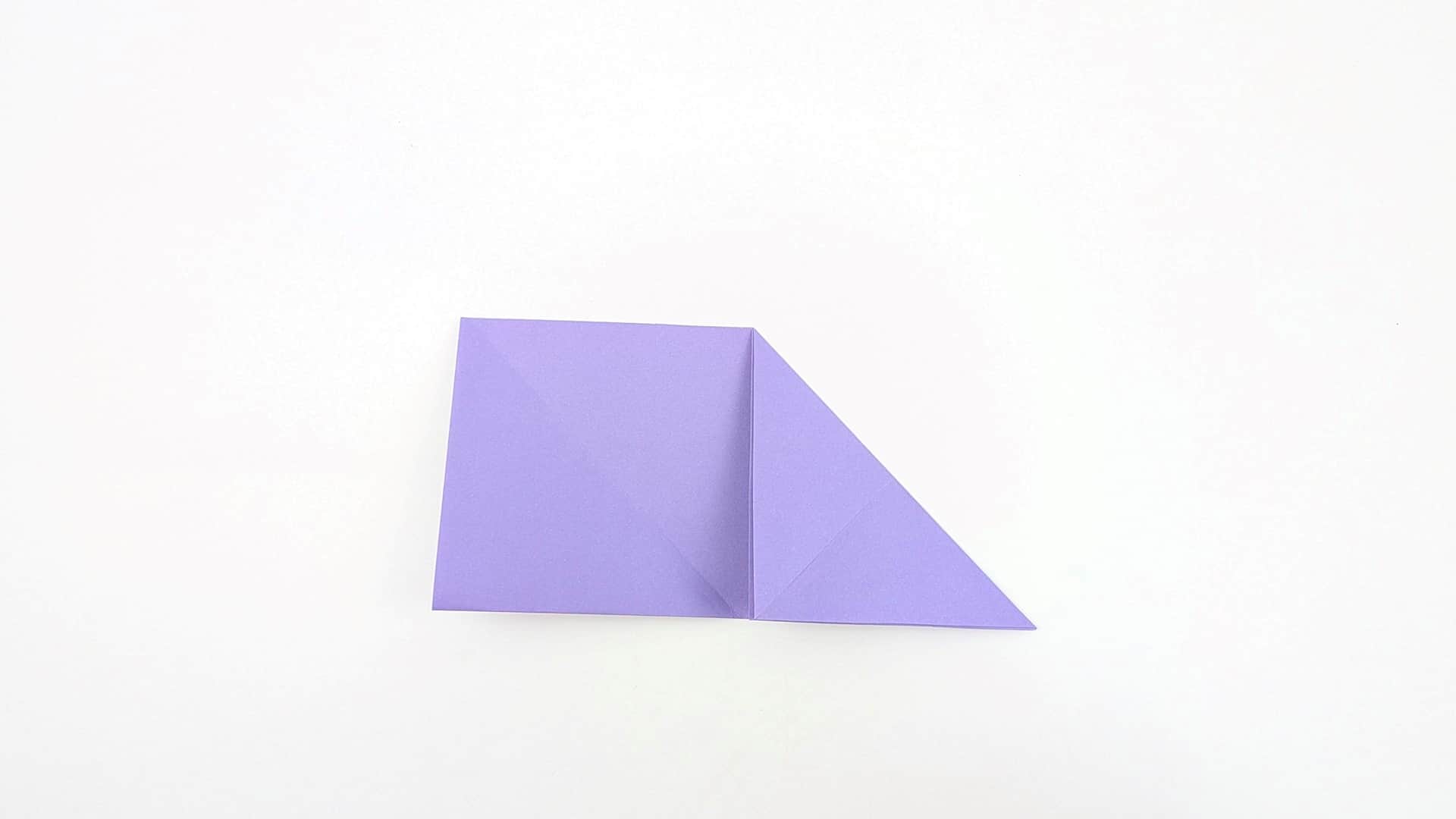 Fold only the right side up along the diagonal crease. The left stays flat as a square while the right becomes a raised triangle.