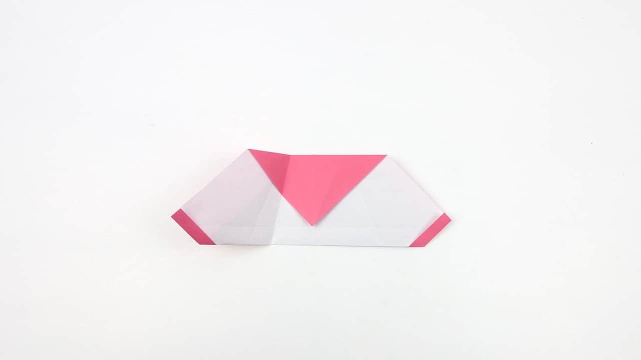 Crease the neck fold so the head sits at a slight forward angle, not straight up.