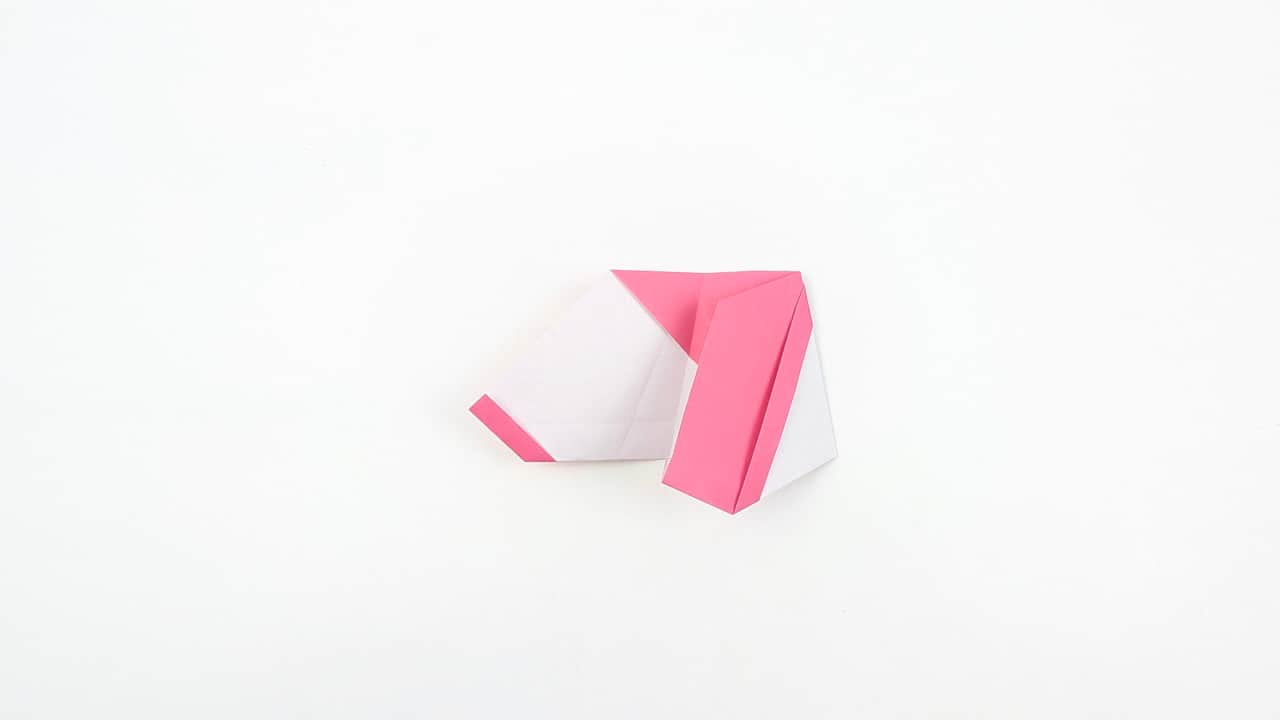Turn the model so the bottom faces you. Fold the front bottom point outward to form the right foot.