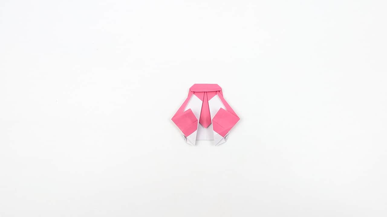 Crease the wing folds softly — you want a subtle angle, not a sharp fold.