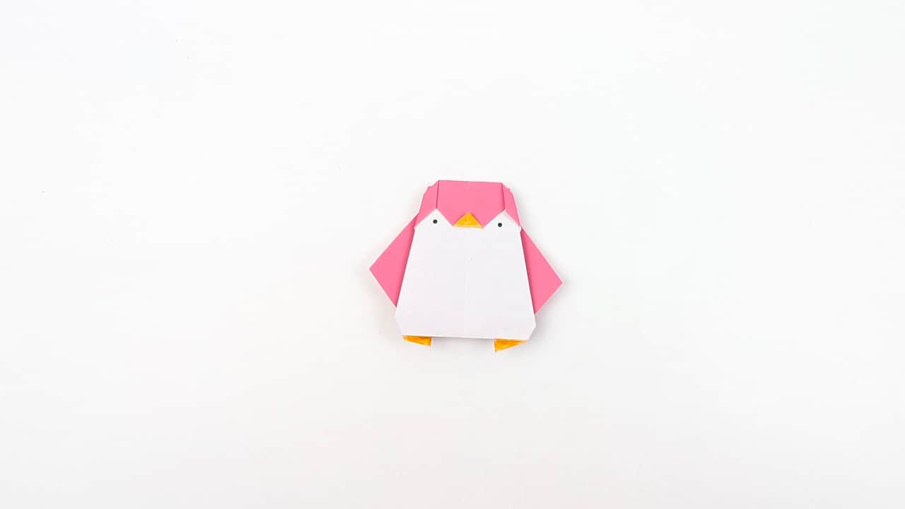 Your origami penguin is complete! Set it on a flat surface — it stands upright on its own.