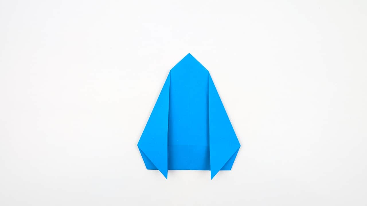 Fold the left flap of the tail section upward in the mirror image to form the left tail fin.