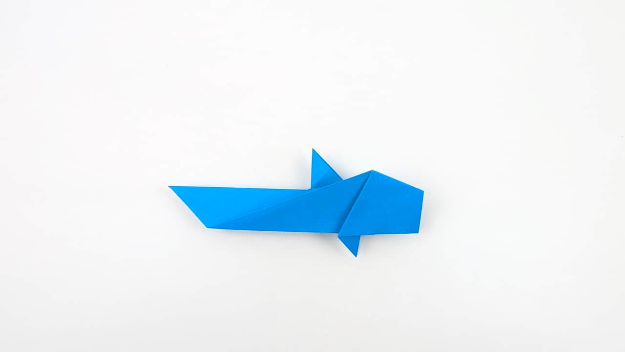 Fold small triangular points on each side of the lower jaw to suggest teeth.