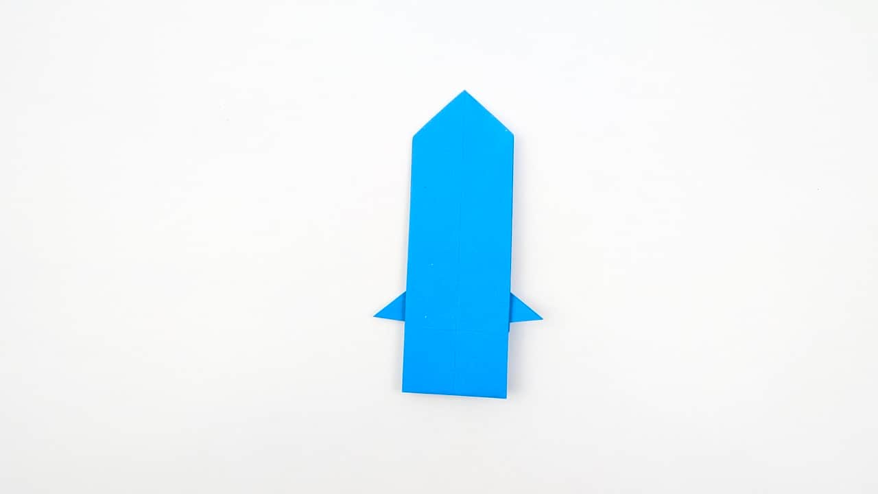 Rotate to view the model upright from the front. The body forms a tall narrow rectangle with a pointed top and small pectoral fin stubs at the sides.