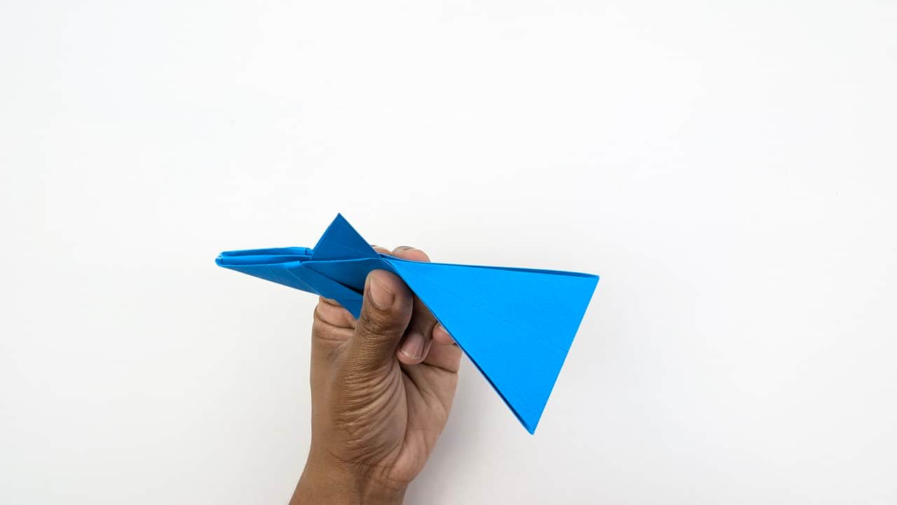 Hold the shark from behind — the hand grip shows the 3D cone of the body. The tail fins and body form a solid triangular shape when viewed from this angle.