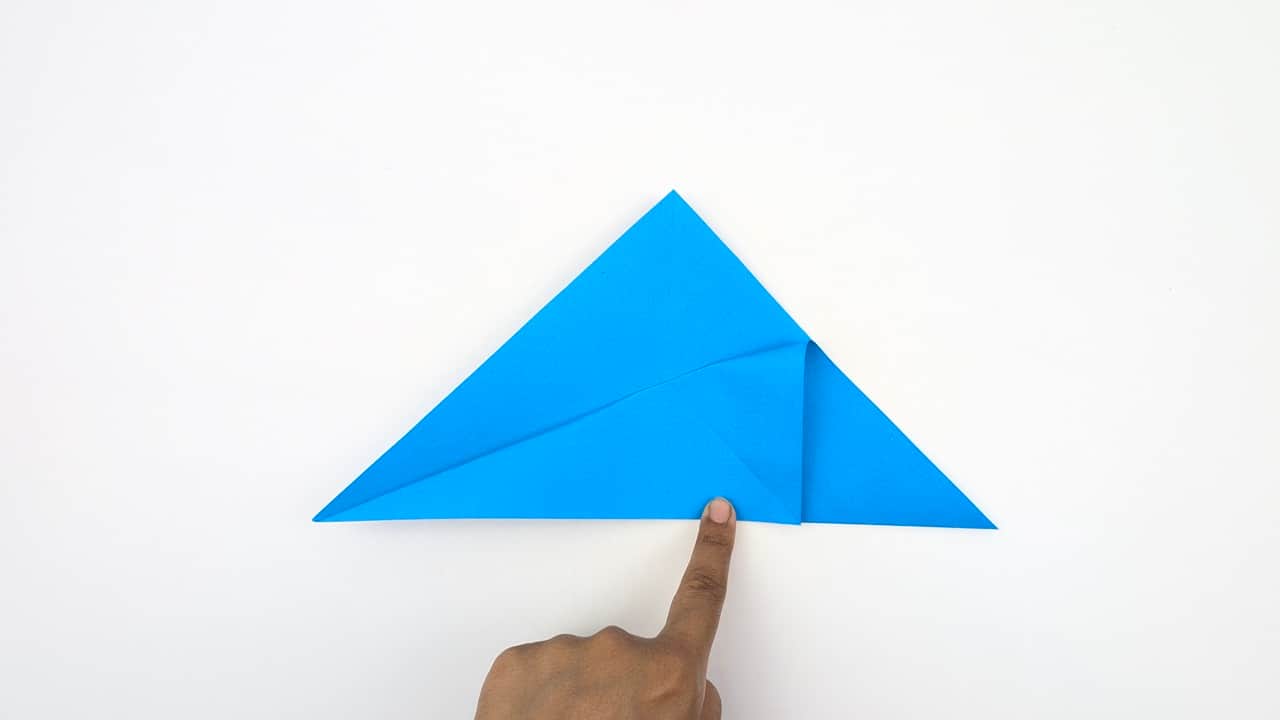 Bring the top point down to the bottom point while pushing the sides inward to collapse into a preliminary base (square base).