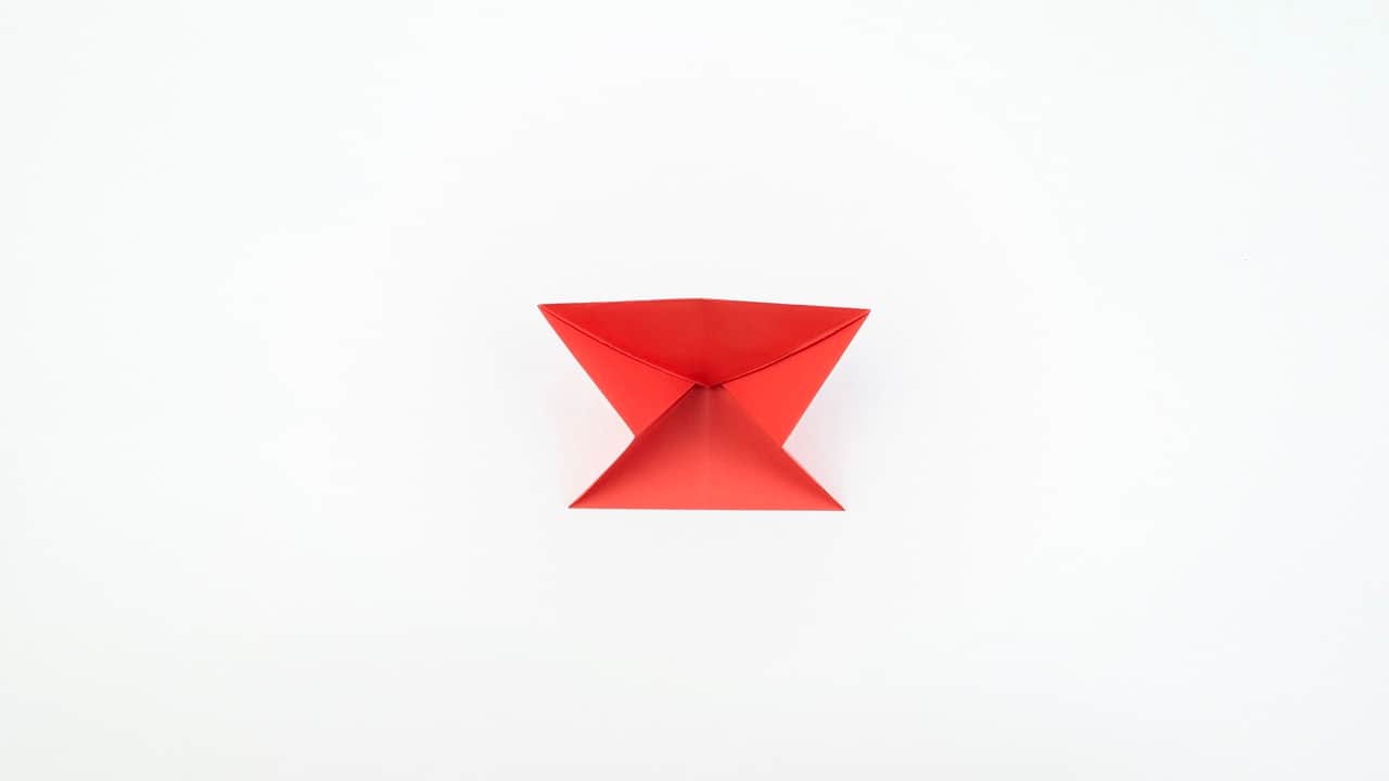 Fold the left leg outward at a downward angle, mirroring the right leg.