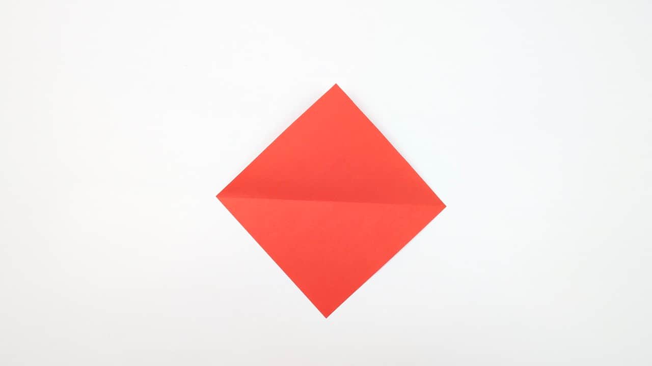 Press all four triangular flaps flat. This is the blintz base.